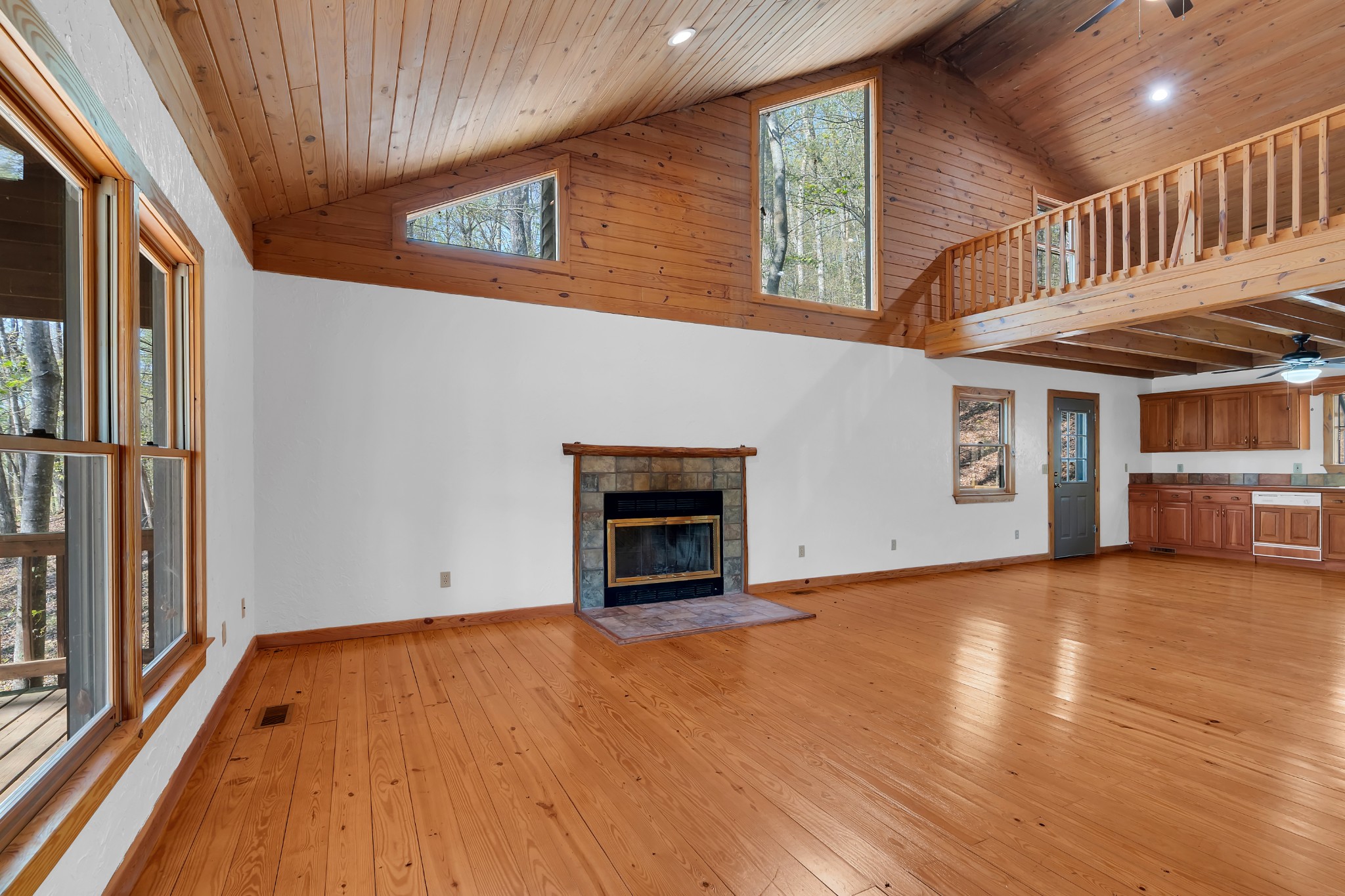 551 Shippmans Creek Road Wartrace, TN 37183 - Photo 3 of 75 an empty room with wooden floor fireplace and windows