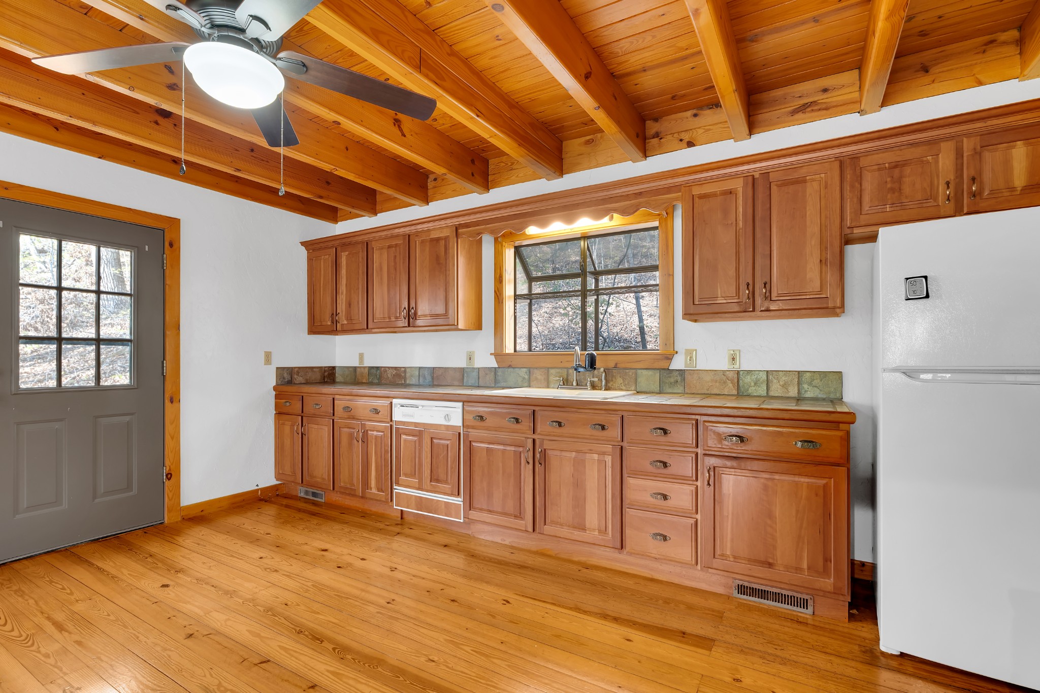 551 Shippmans Creek Road Wartrace, TN 37183 - Photo 7 of 75 a kitchen with granite countertop wooden cabinets and white appliances