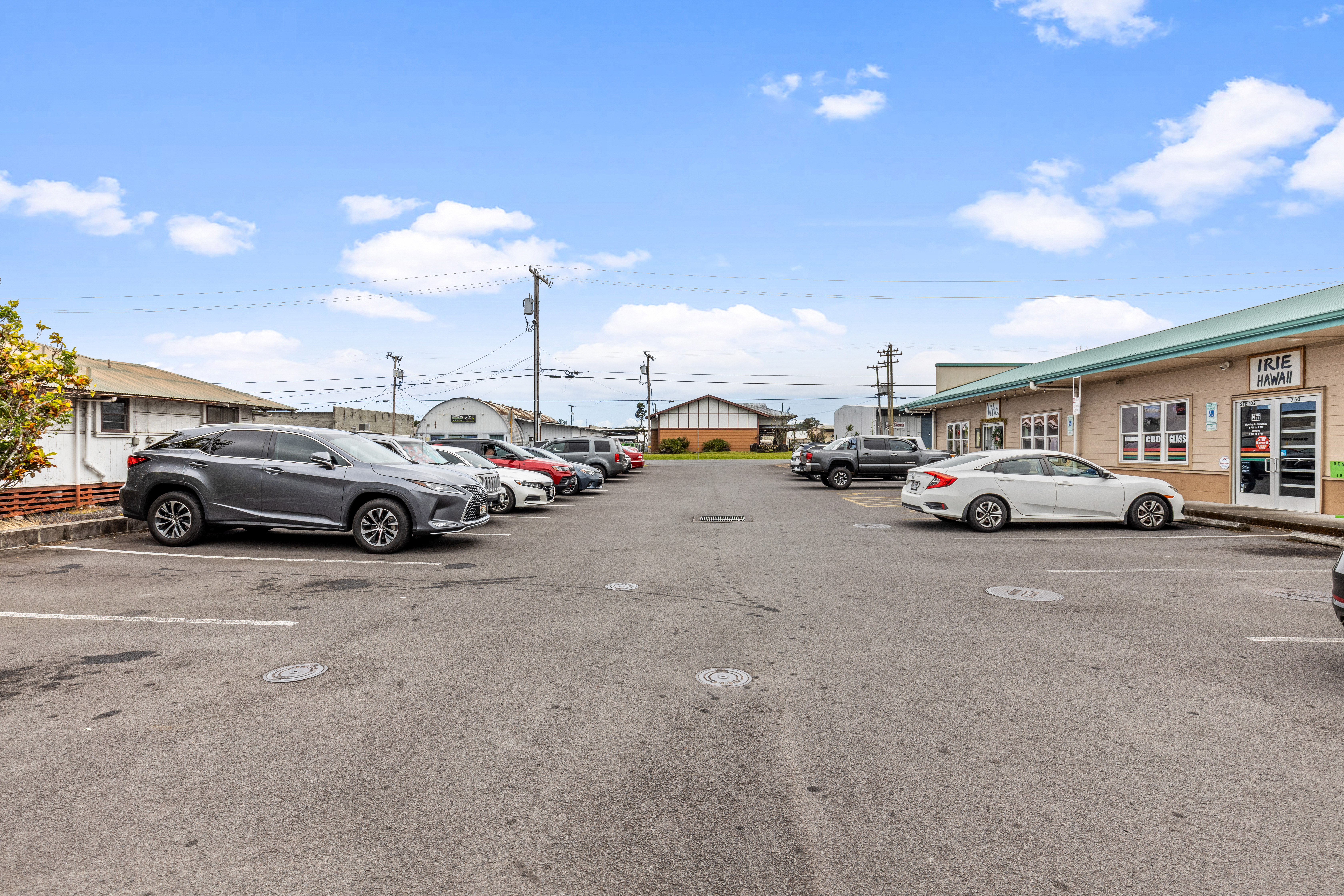 750 Kanoelehua Avenue, Unit 4 Hilo, HI 96720 - Photo 14 of 25 a view of cars parked in front of a building