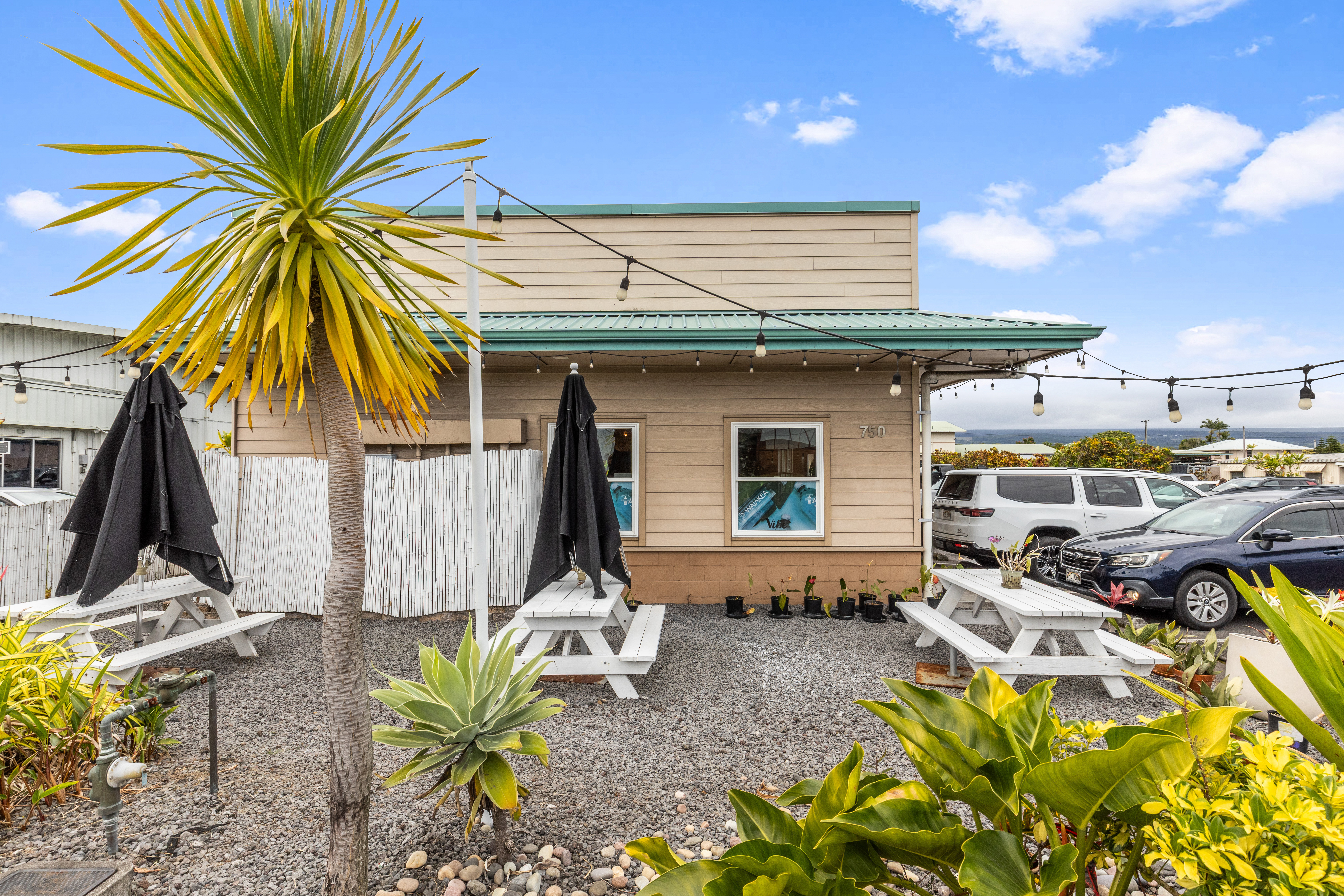 750 Kanoelehua Avenue, Unit 4 Hilo, HI 96720 - Photo 18 of 25 a front view of a house with a garden