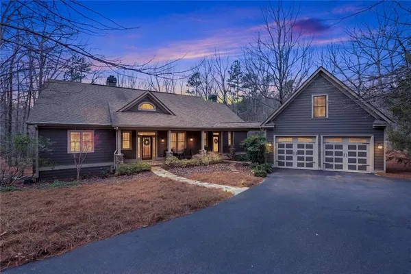 a view of a house with a yard and garage