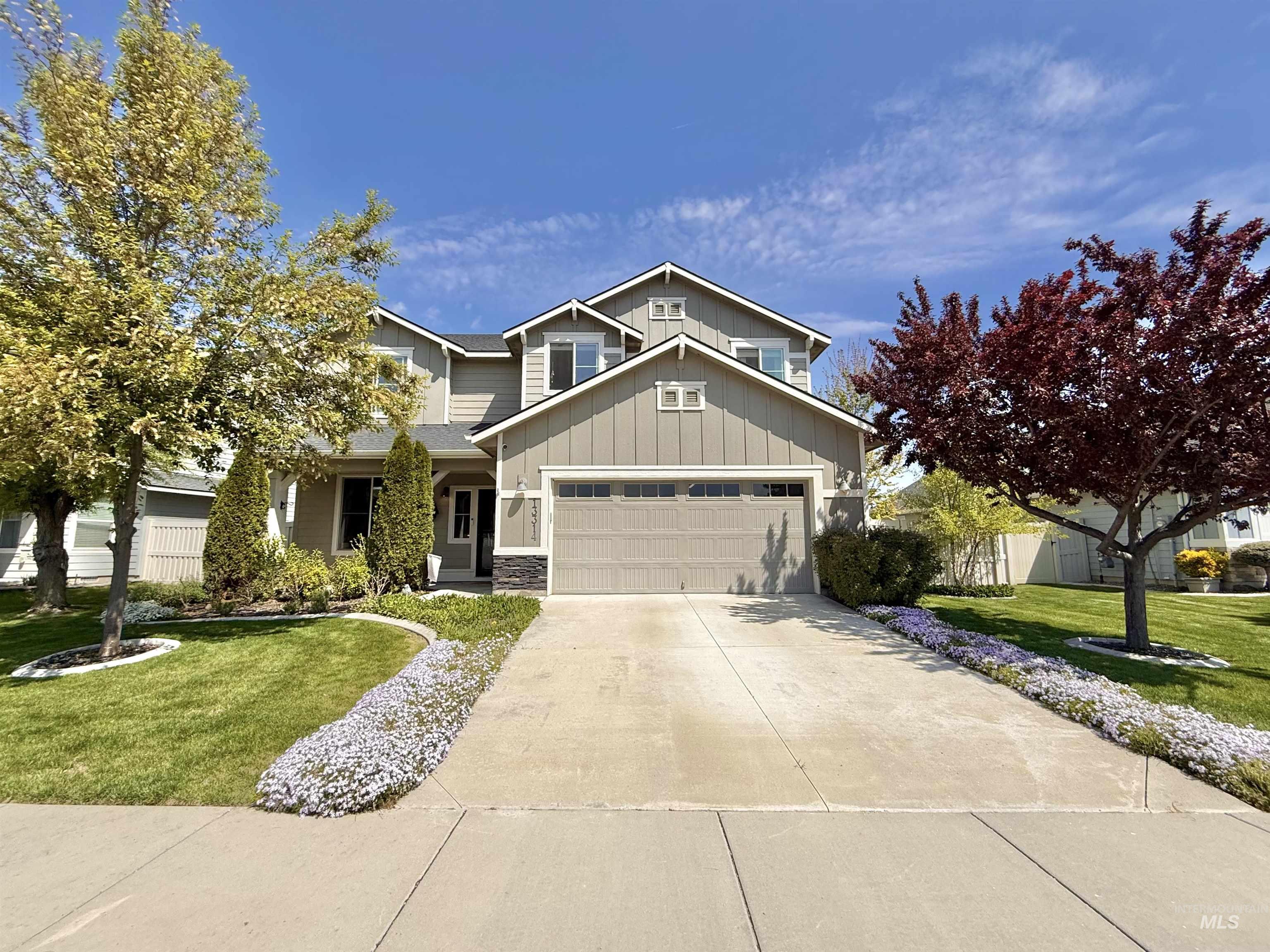 13314 Bloomfield Drive Caldwell, ID 83607 - Photo 1 of 32 Two-story residence featuring light gray siding with dark stone accents