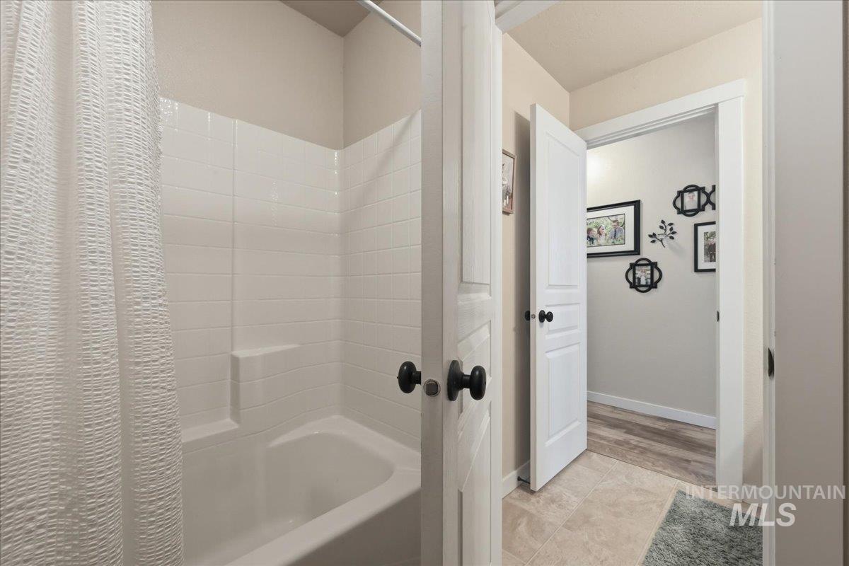 13314 Bloomfield Drive Caldwell, ID 83607 - Photo 14 of 32 Bathroom featuring shower / tub combo and baseboards