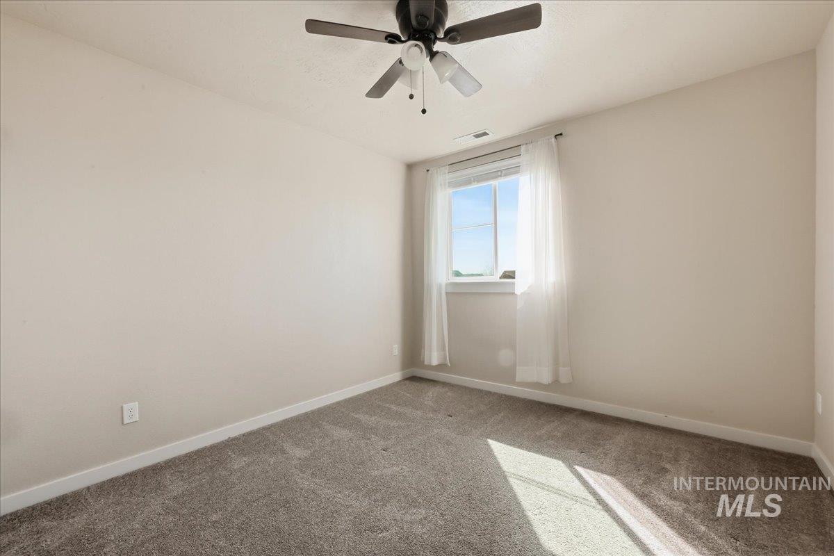 13314 Bloomfield Drive Caldwell, ID 83607 - Photo 17 of 32 Empty room with carpet and a ceiling fan