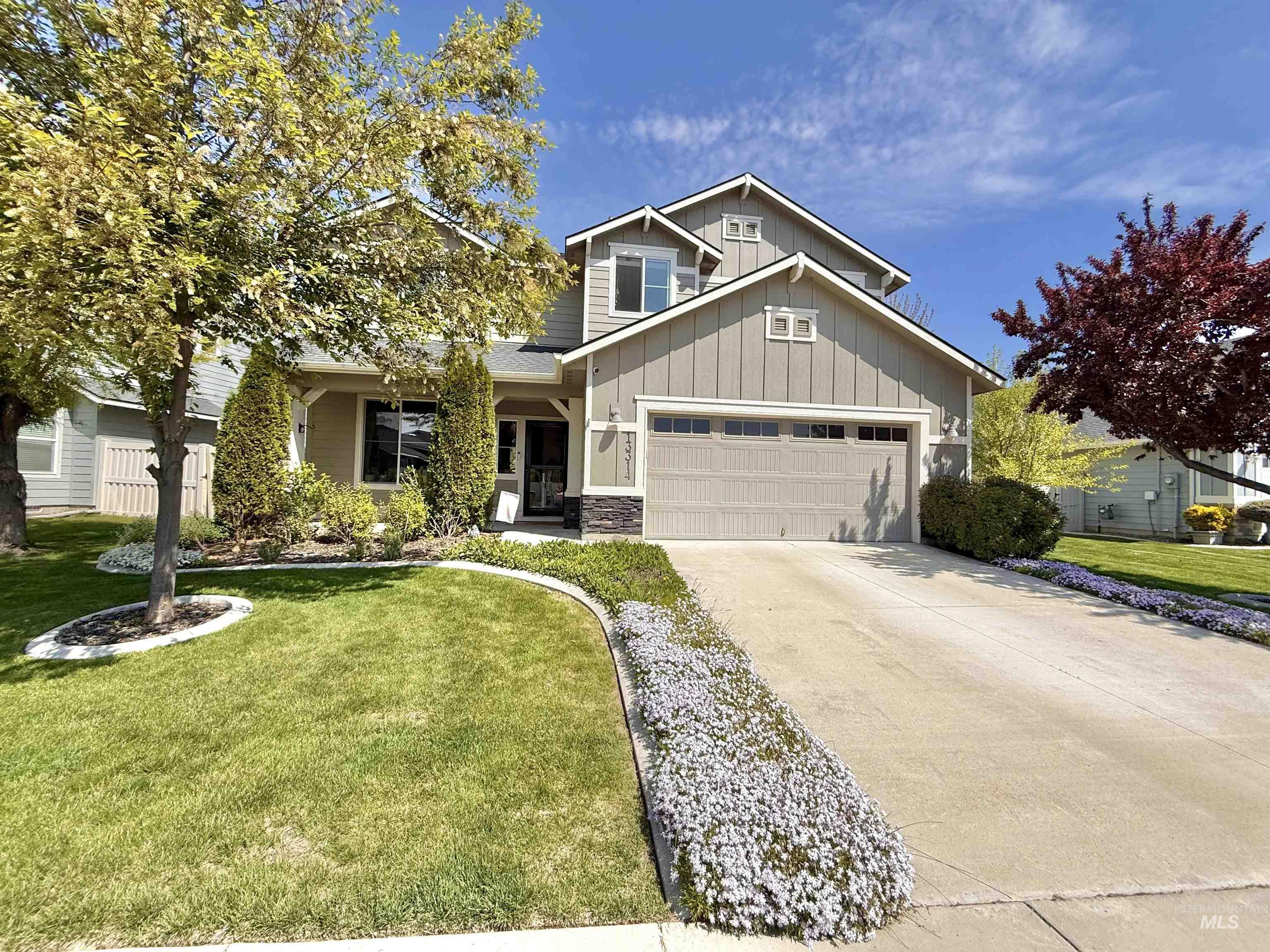 13314 Bloomfield Drive Caldwell, ID 83607 - Photo 28 of 32 Two-story residence featuring a two-car garage, stone accents, and a covered entry