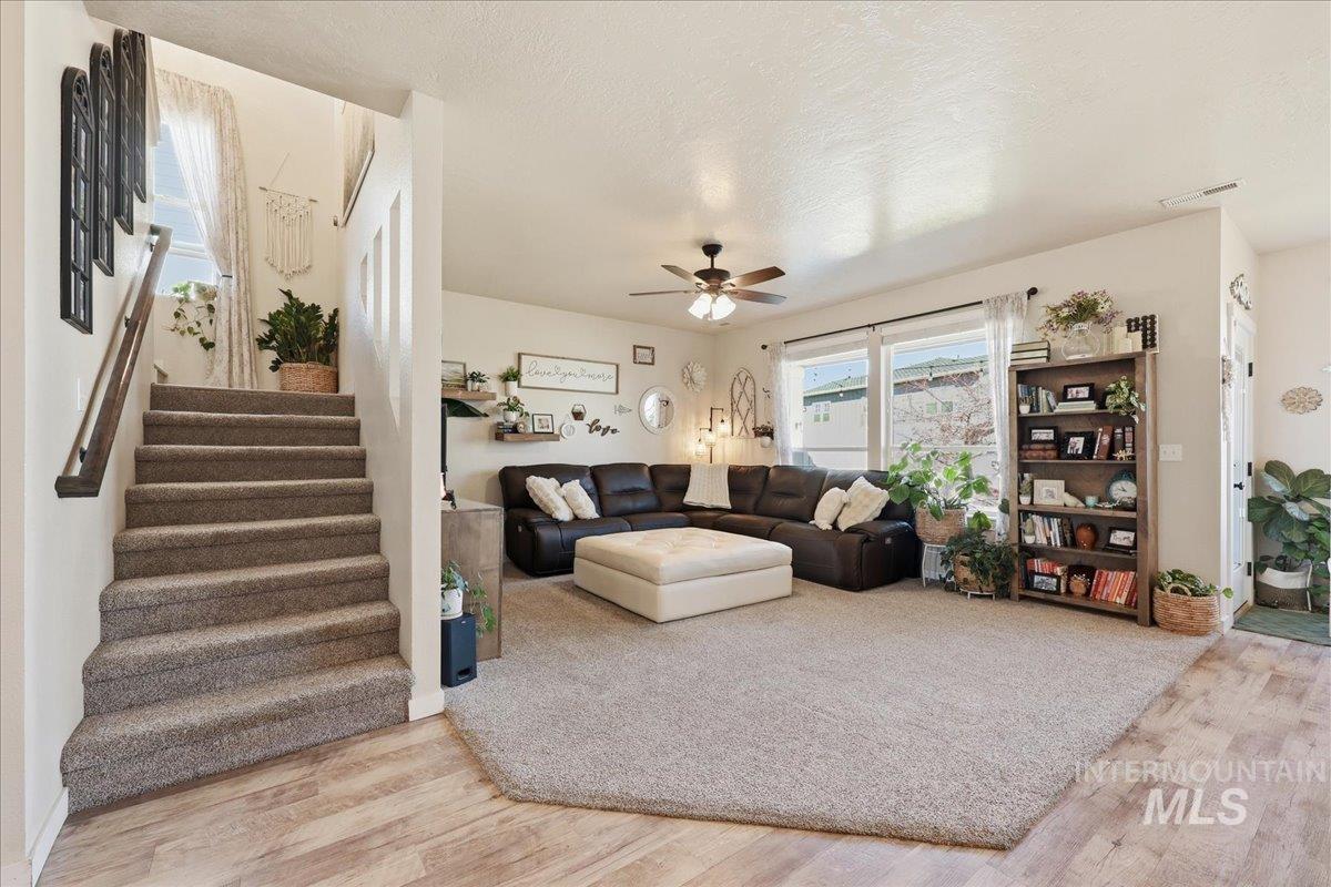 13314 Bloomfield Drive Caldwell, ID 83607 - Photo 7 of 32 Living area with ceiling fan, light wood-type flooring, and a textured ceiling