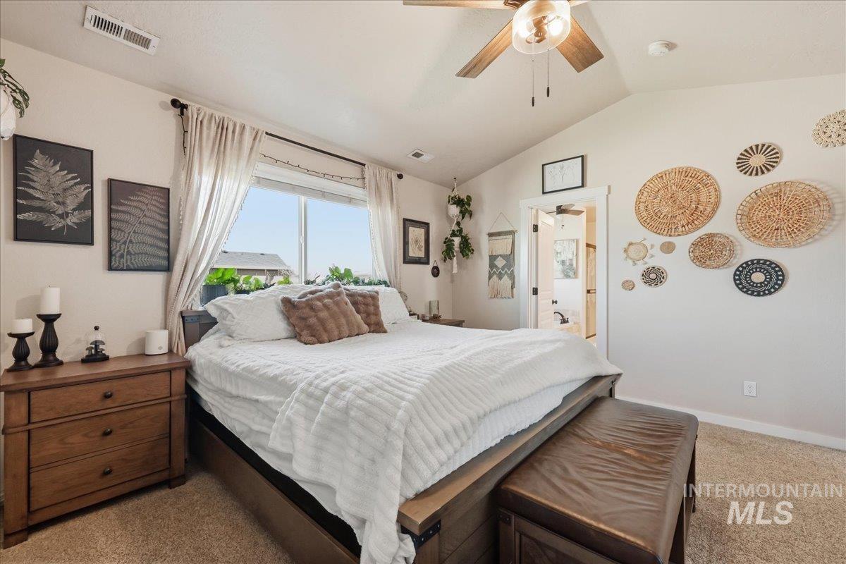 13314 Bloomfield Drive Caldwell, ID 83607 - Photo 9 of 32 Carpeted bedroom with vaulted ceiling and ceiling fan