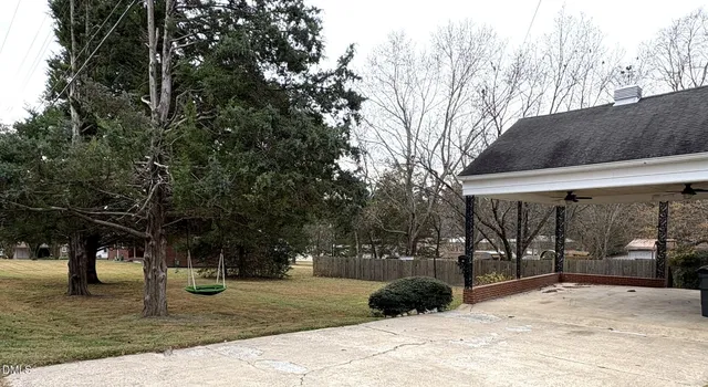 a view of a park with large trees