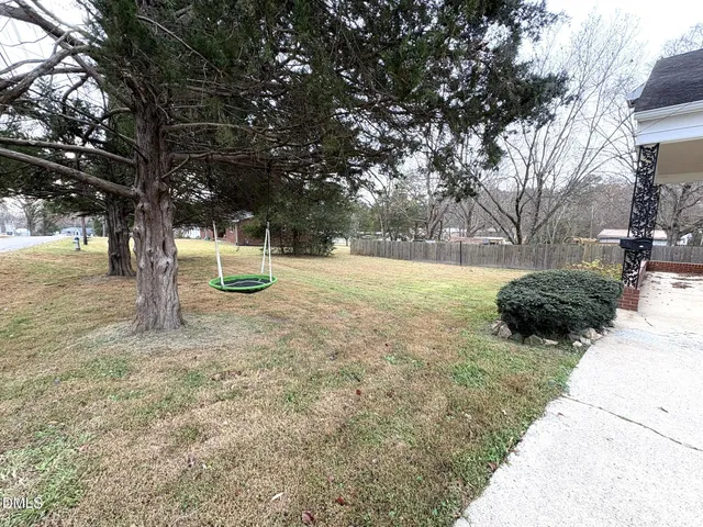 a view of a yard with a tree