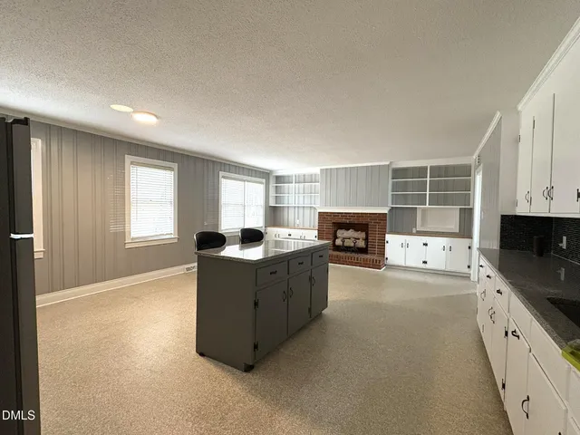 a kitchen with furniture a stove and a window