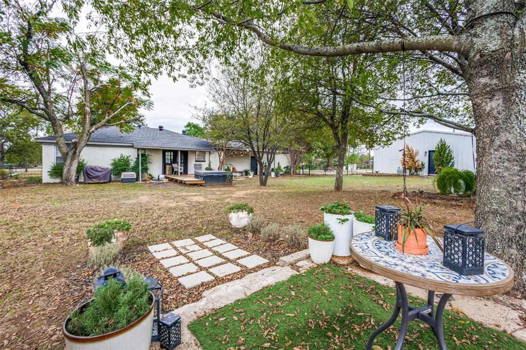 1200 Tipps Road Cross Roads, TX 76227 - Photo 27 of 32 a front view of a house with garden