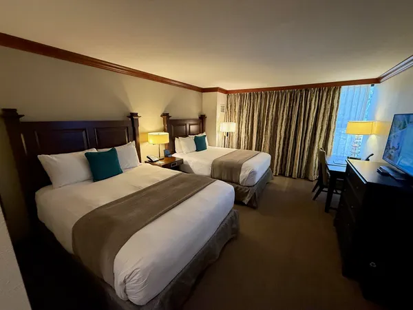 a large bedroom with bed and window