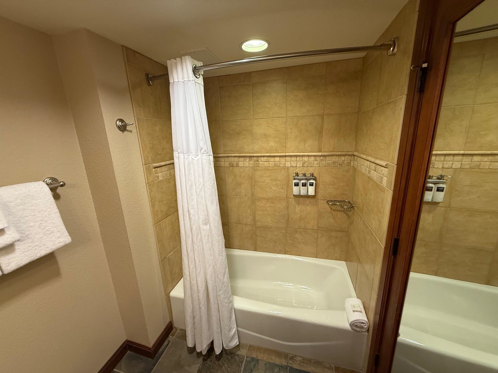 400 Resort Road, Unit 532 Olympic Valley, CA 96146 - Photo 9 of 21 a bathroom with a tub and a shower