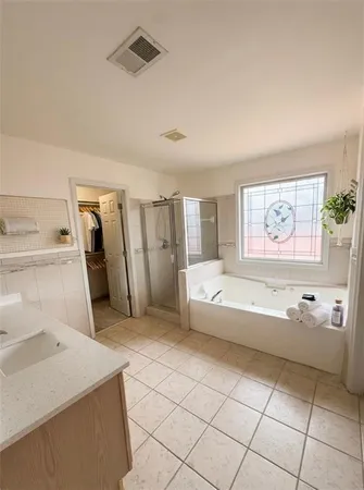 a spacious bathroom with a bathtub and a shower