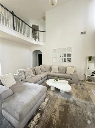 a living room with furniture white walls and a fireplace