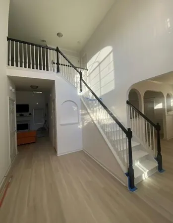 a view of staircase with white walls and stairs