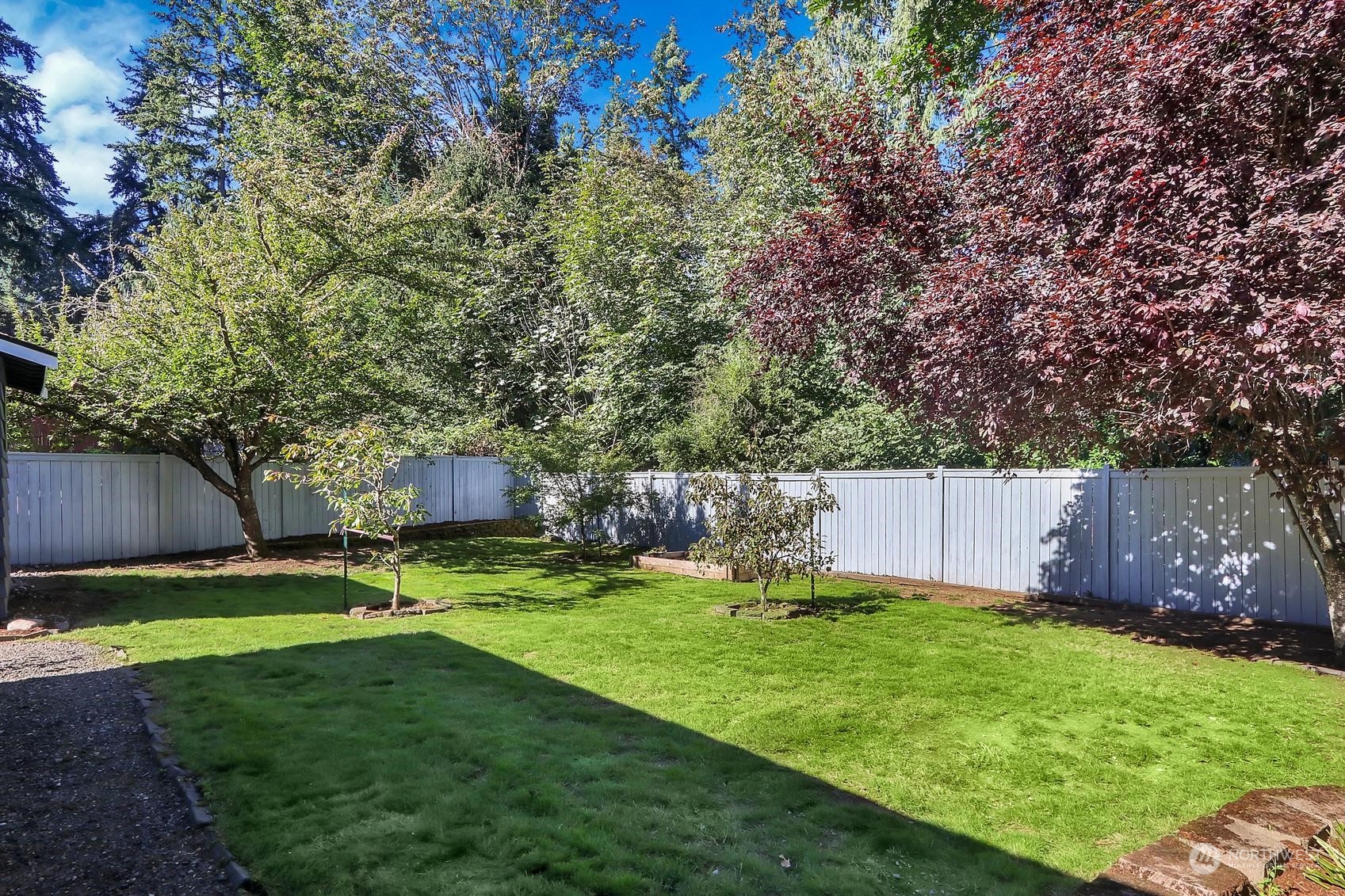 103 231st Street Southeast Bothell, WA 98021 - Photo 27 of 33 a view of a backyard with table and chairs and wooden fence