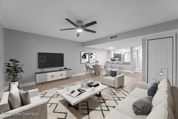 a living room with furniture a rug and a flat screen tv