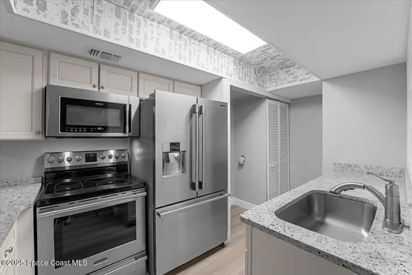 a kitchen with a sink stove and refrigerator