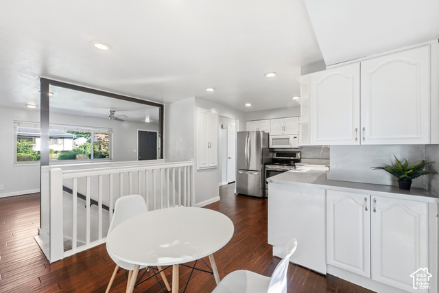 8746 Gladiator Way Sandy, UT 84094 - Photo 2 of 36 Kitchen featuring white cabinetry, stainless steel appliances, recessed lighting, and wood-finish flooring