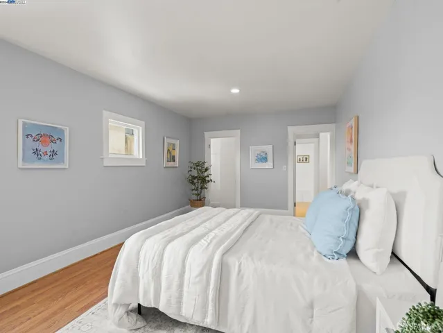 a bedroom with a bed and painting on the wall