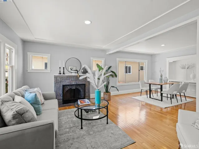 a living room with furniture a fireplace and a table