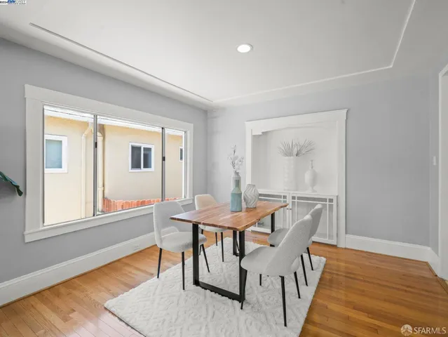 a dining room with furniture and wooden floor