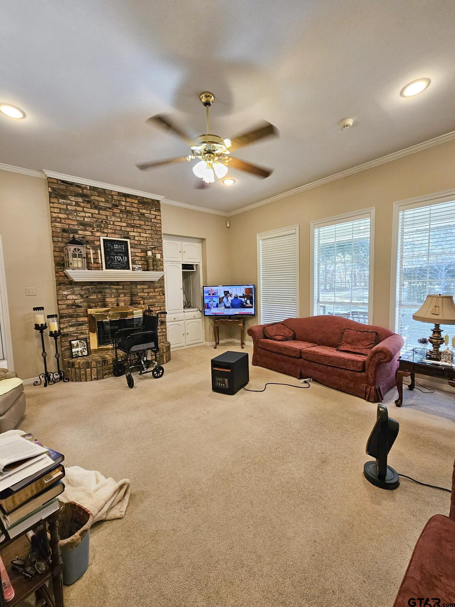 2001 Venture View Palestine, TX 75803 - Photo 11 of 28 a living room with furniture a fireplace and a chandelier