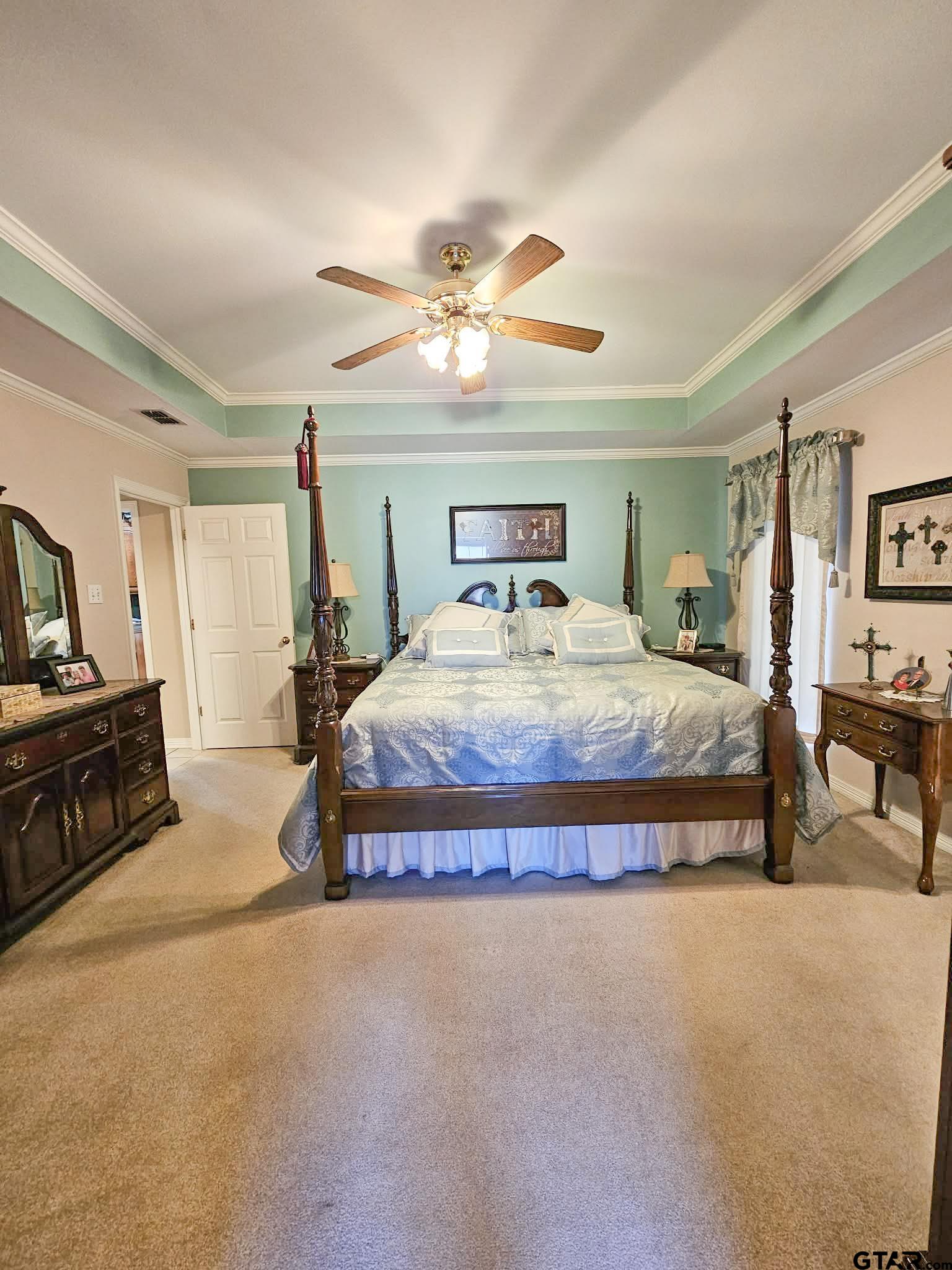 2001 Venture View Palestine, TX 75803 - Photo 16 of 28 a spacious bedroom with a bed a dresser and a chandelier