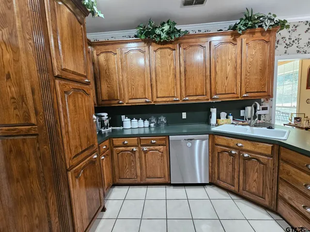 a spacious bathroom with a tub shower and checkered floor