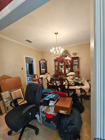 a living room with furniture and a ceiling fan
