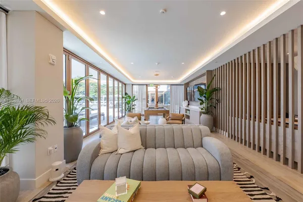 a living room with furniture and a potted plant