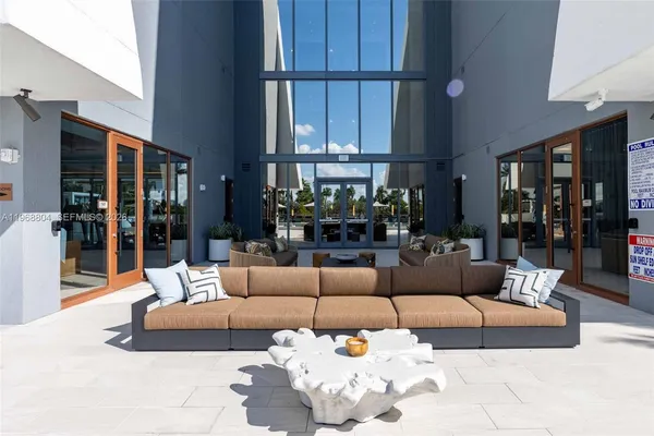 a view of a white house with a yard and sitting area