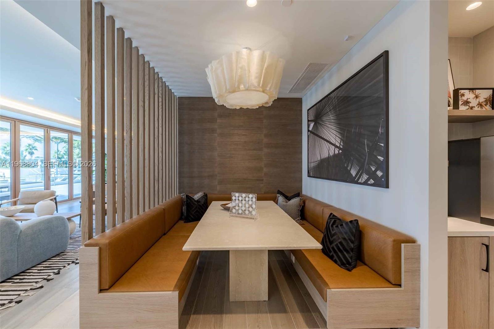 3900 Alton Road, Unit 422 Miami Beach, FL 33140 - Photo 29 of 42 a living room with furniture and a chandelier