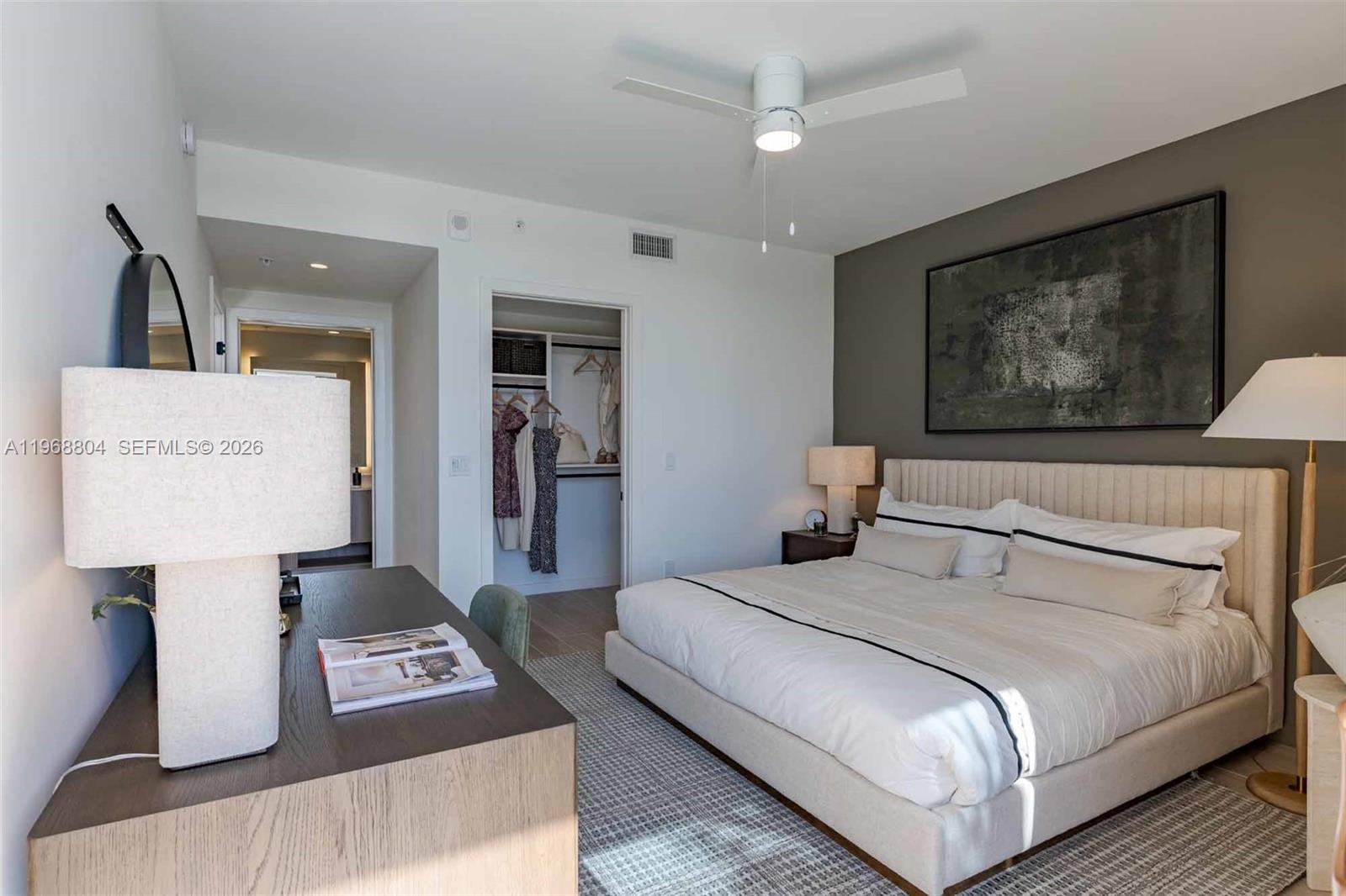 3900 Alton Road, Unit 422 Miami Beach, FL 33140 - Photo 4 of 42 a bedroom with a bed and a lamp on table