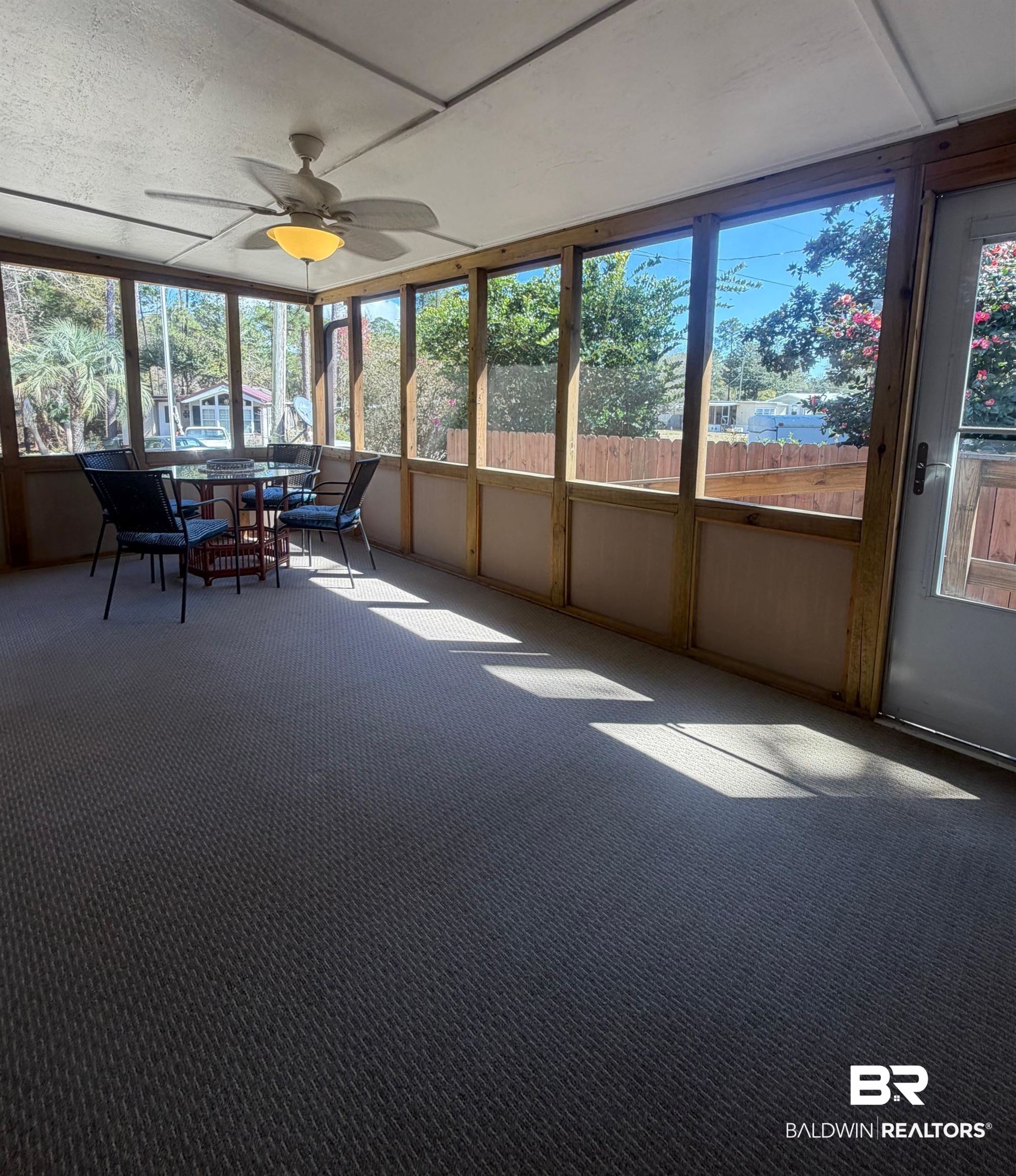 685 Escambia Loop Lillian, AL 36549 - Photo 2 of 43 Sunroom / solarium with a ceiling fan and outdoor dining space