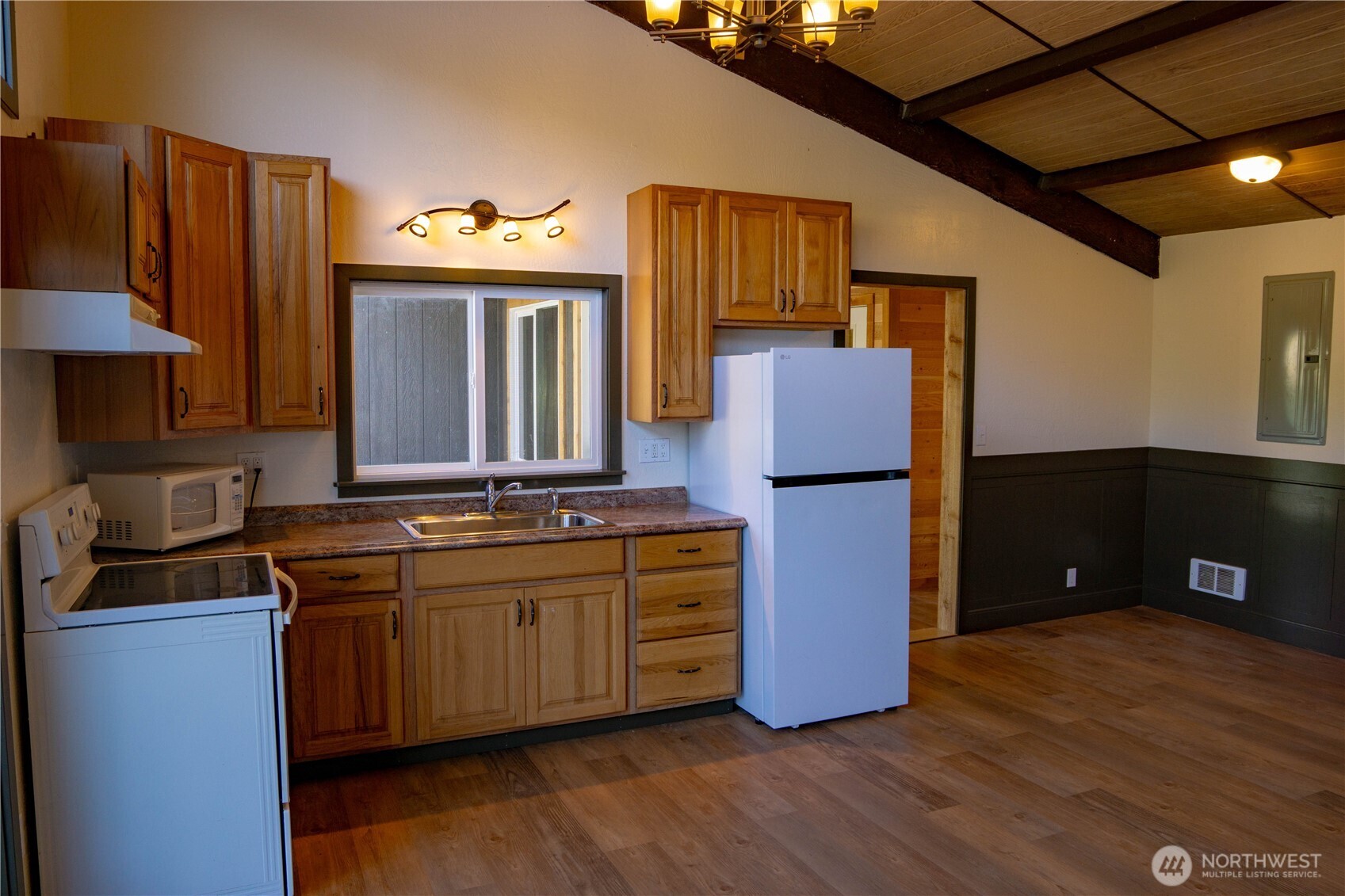 570 South Shore Road Port Angeles, WA 98363 - Photo 27 of 40 a kitchen with stainless steel appliances granite countertop a refrigerator a stove a sink and a microwave