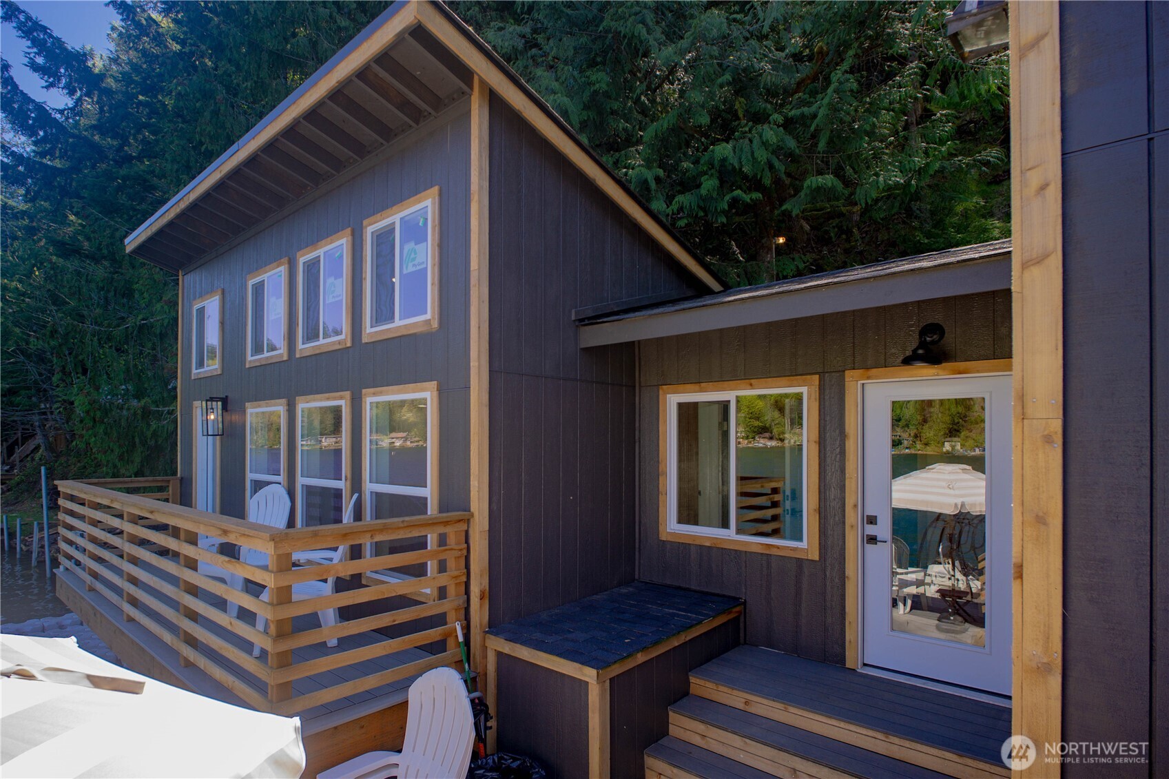 570 South Shore Road Port Angeles, WA 98363 - Photo 4 of 40 a backyard of a house with wooden floor and outdoor seating