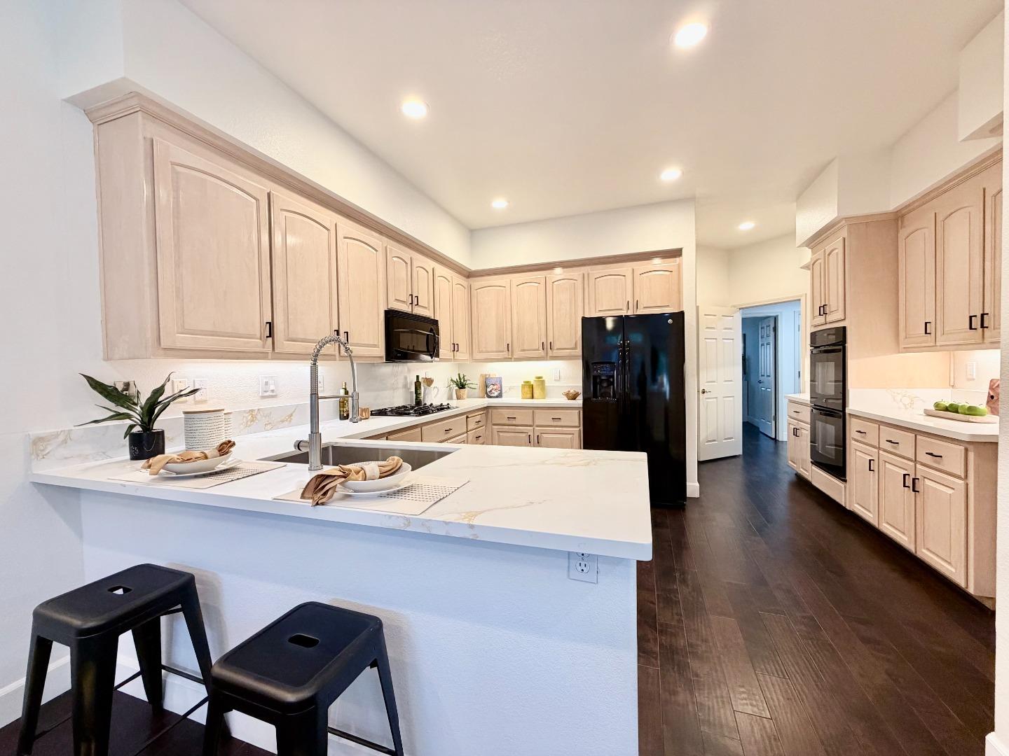 8718 McCarty Ranch Drive San Jose, CA 95135 - Photo 11 of 60 a kitchen with refrigerator cabinets and wooden floor