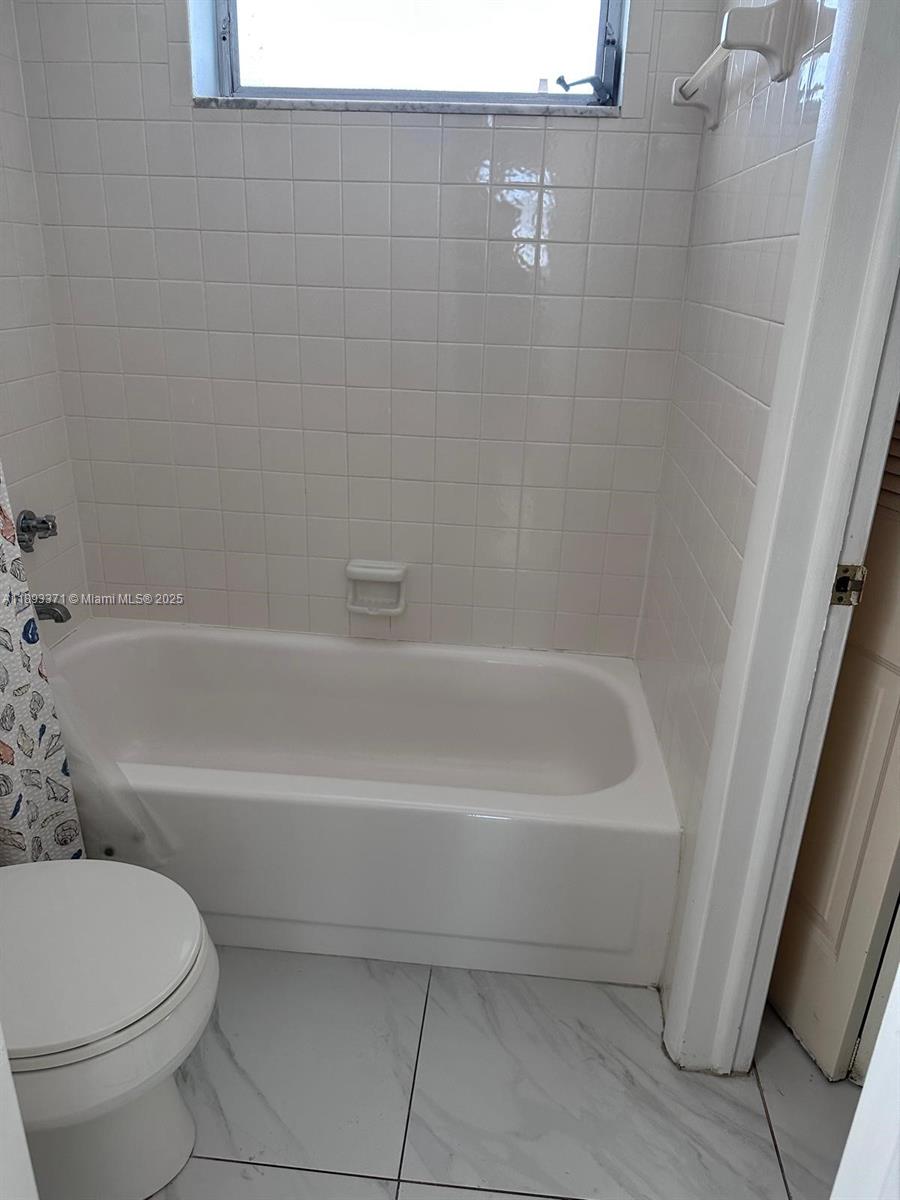 6021 Northwest 61st Avenue, Unit 208 Tamarac, FL 33319 - Photo 12 of 17 a bathroom with a toilet and a bathtub