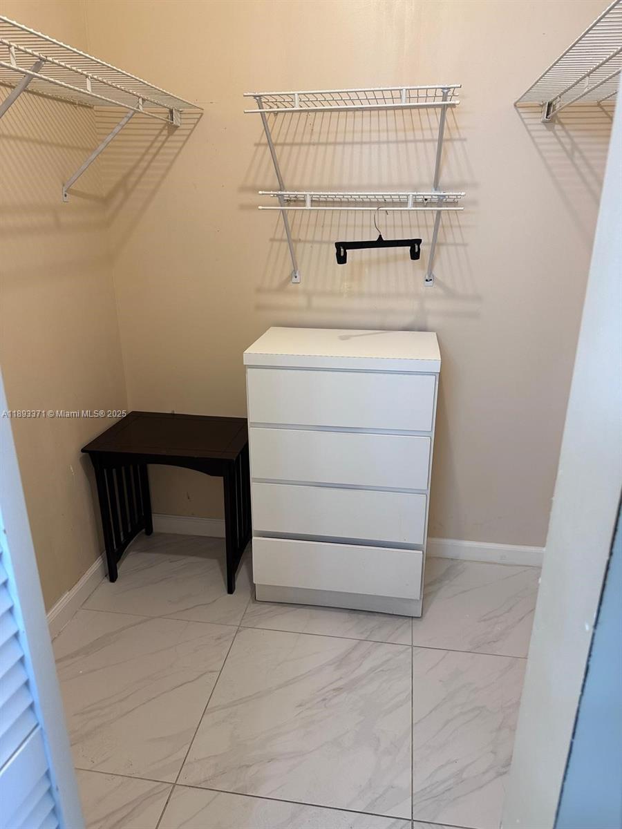 6021 Northwest 61st Avenue, Unit 208 Tamarac, FL 33319 - Photo 14 of 17 a bathroom with a sink a vanity and shower