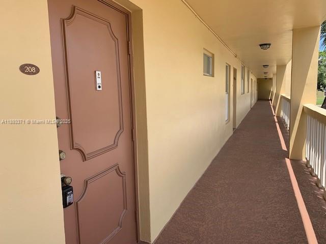 6021 Northwest 61st Avenue, Unit 208 Tamarac, FL 33319 - Photo 15 of 17 a view of a hallway with a door