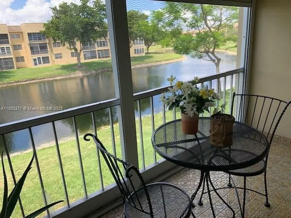 a view of a chairs and table in the balcony