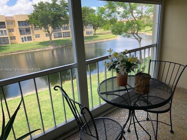 6021 Northwest 61st Avenue, Unit 208 Tamarac, FL 33319 - Photo 6 of 17 a view of a chairs and table in the balcony