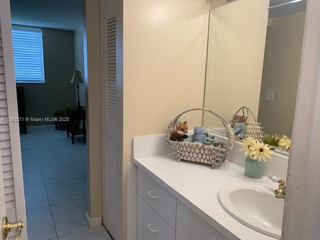 6021 Northwest 61st Avenue, Unit 208 Tamarac, FL 33319 - Photo 9 of 17 a bathroom with a sink and a mirror