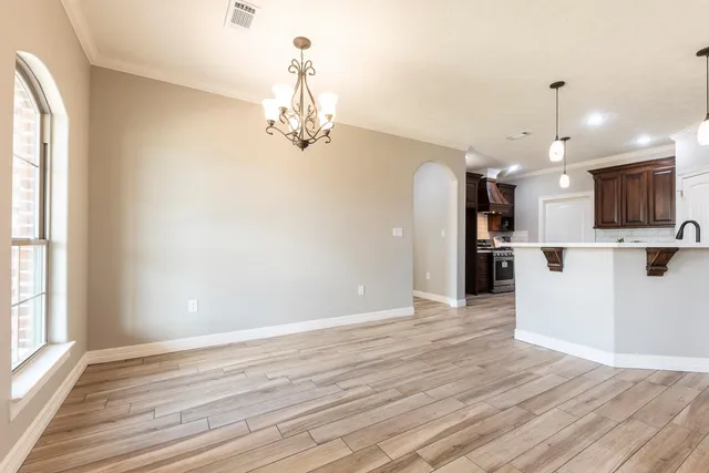 a view of a kitchen with a dishwasher and wooden floor