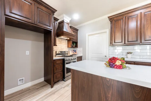 a kitchen with stainless steel appliances granite countertop a refrigerator and microwave
