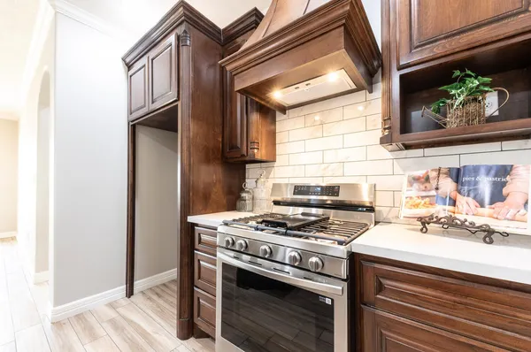 a kitchen with stainless steel appliances a stove a sink and a refrigerator