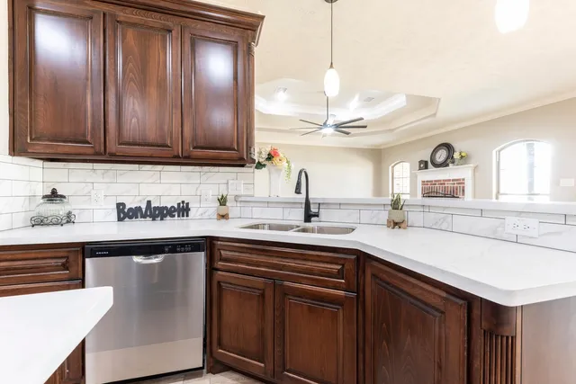 a kitchen with stainless steel appliances granite countertop a sink a stove and cabinets