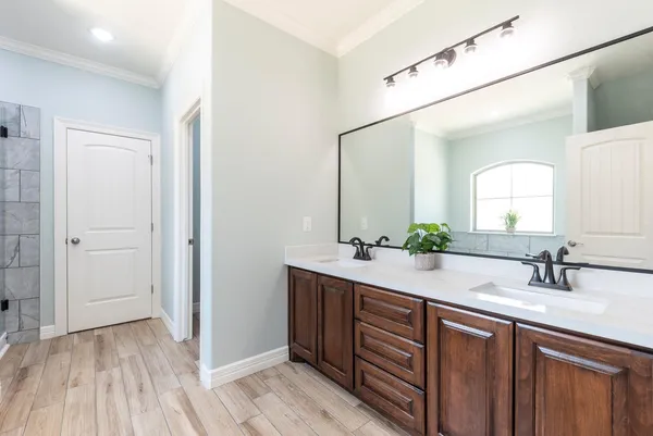 a bathroom with a double vanity sink and mirror
